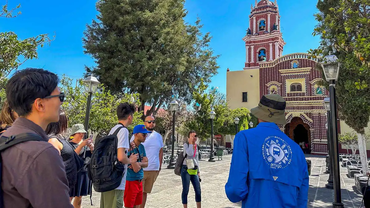 The tiled dome of a church in Cholula with the volcano behind, on a Puebla and Cholula day tour from Mexico City
